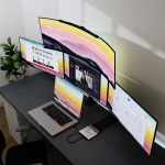 mbeat USB-C Quad 4K DisplayLink Adapter connecting MacBook to three extended 4K monitors on desk